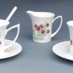 A Set of Three Over Glazed Floral Tea Cups